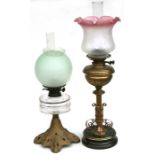 A Victorian oil lamp with brass reservoir and column and etched glass shade, 60cms high; together