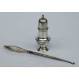 A George III style silver pepperette, Chester, date letter rubbed; together with a silver handled