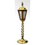 A brass table lamp in the form of a street lamp with an open twist column, 48cms high.