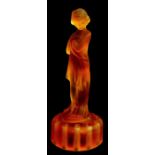 An Art Deco moulded frosted amber glass table centrepiece in the form of a scantily clad lady,