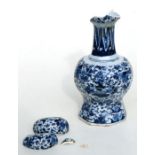 A Delft blue & white vase decorated with flowers (a/f), 23cms high.
