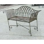 A wrought iron two-seater garden bench with scroll arms and arched back, 130cms wide.