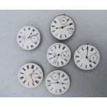 A group of pocket watch dials and movements.