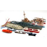 A Motor Max battery operated gun boat, 69cms long; together with similar boats and wooden boats (