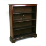 An Edwardian walnut open bookcase with three shelves, on bracket feet, 77cms wide.