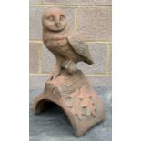 A terracotta style ridge tile depicting an owl. 41cm high