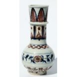 A Chinese underglaze blue, white and red vase decorated with scrolling flowering foliage, 23.5cms