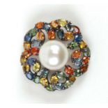 An 18ct white gold pendant / brooch set with multi colour sapphires and a large central pearl,