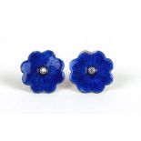 A pair of silver enamel and diamond set flower shaped stud earrings.