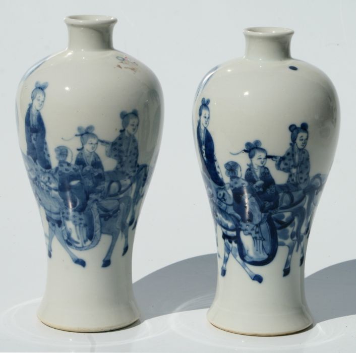 A pair of Chinese blue & white meiping vases decorated with figures and horses in a landscape, 23cms