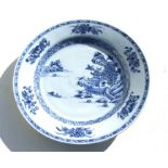 A Chinese under glazed blue porcelain plate decorated with a landscape scene, 23cms diameter.