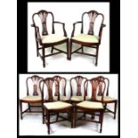 A set of eight Hepplewhite style mahogany dining chairs with pierced vase shaped splats, drop-in