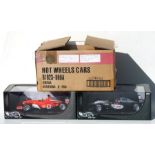 A Hot Wheels 1:18 scale F2002 Ferrari F1 driven by Rubens Barrichello and another McLaren MP4-17D
