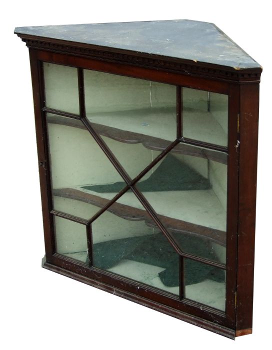 A 19th century mahogany corner cupboard, the astragal glazed door enclosing a shelved interior,