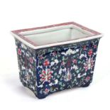 A Chinese famille rose planter decorated with flowers on a blue ground, 23cms wide.