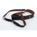 An officers black leather Sam Browne belt with cross strap and military marked whistle