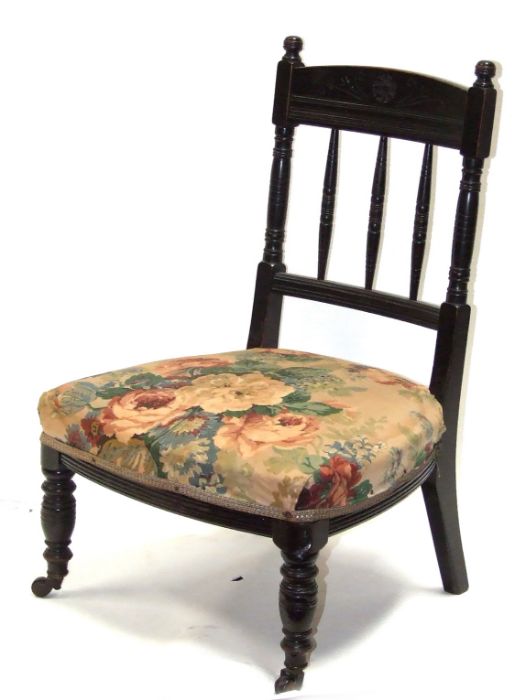 A late 19th century ebonised Godwin style design nursing chair with upholstered seat, on turned