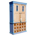 A continental painted pine larder cupboard on drawers, the upper section with a pair of panelled