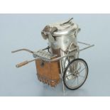 A Chinese silver coloured metal table vesta in the form of a hand cart, weight 210g, 17cms wide.