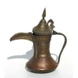 A Turkish / Islamic copper & brass dallah coffee pot, 23cms high.