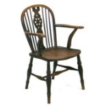 A 19th century beech and elm wheel back armchair with solid seat and turned front legs joined by a