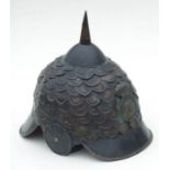 An unusual reproduction 19th century military spiked metal helmet with VR cypher badge