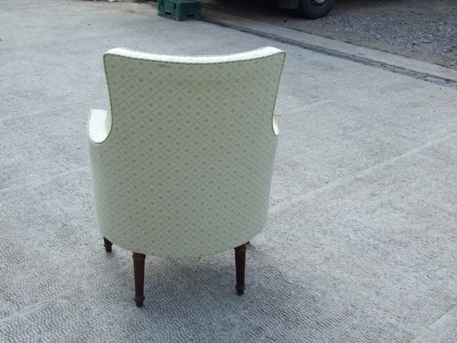 A French upholstered armchair on turned and reeded legs. - Image 2 of 2