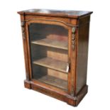 A Victorain figured walnut Pier cabinet, the single glazed door enclosing a shelved interior, with