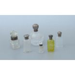 A Mappin & Webb silver topped cut glass scent bottle, London 1900; together with five other silver