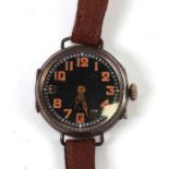 A WWII trench watch with black dial and luminous Arabic numerals, in a silver case with wire work