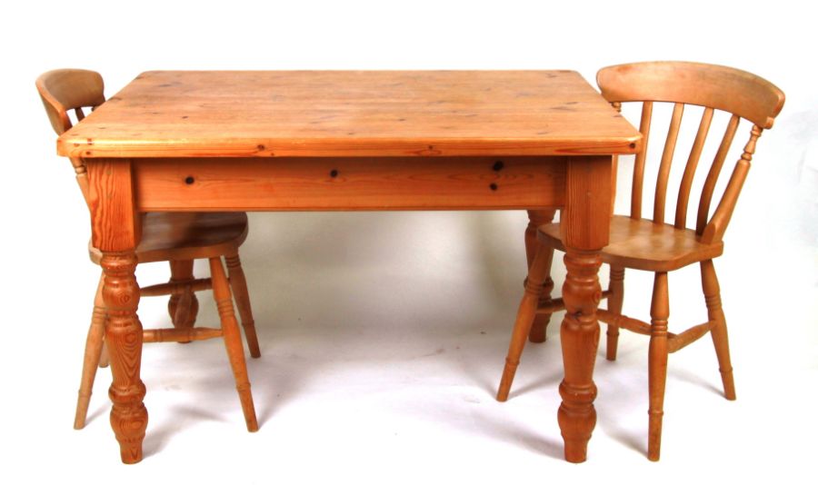 A pine farmhouse table on turned baluster legs, 122cms wide; together with two pine stick back