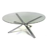 A vintage mid century circular glass coffee table on a chrome a chrome tripod tubular base in the