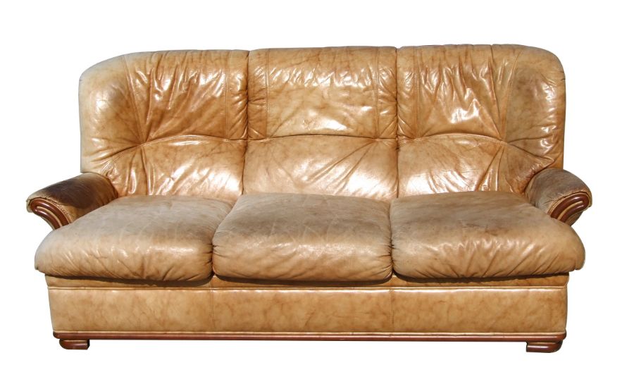 A distressed leather three-seater sofa.