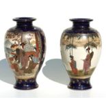 A pair of late 19th / early 20th century Japanese Satsuma vases decorated with figures in a