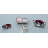 A silver pill box, Birmingham 1903; together with a silver stamp box; and two silver pin cushions (