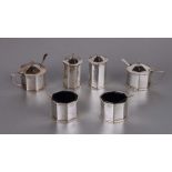 A silver six-piece cruet set comprising two mustard pots, two salt cellars and two pepperette,