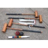 A Jacques style four-person croquet set comprising four mallets, hoops, balls and winning peg.