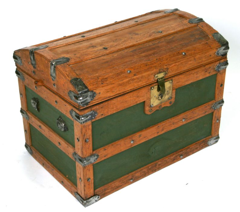 An oak and metal bound dome topped travel trunk, 69cms wide.