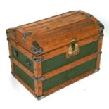 An oak and metal bound dome topped travel trunk, 69cms wide.