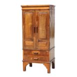 An early 20th century Cotswold school Gimson style side walnut cabinet, the pair of panelled doors