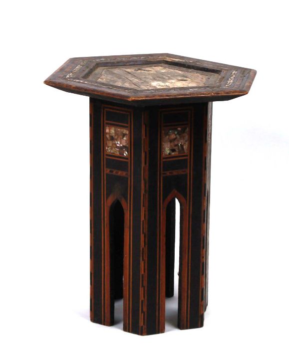 A Moroccan Liberty style octagonal occasional table with ebonised base and mother of pearl inlay,