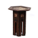 A Moroccan Liberty style octagonal occasional table with ebonised base and mother of pearl inlay,