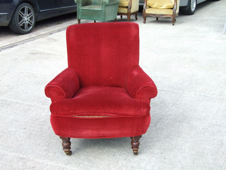 A Victorian red upholstered armchair on turned front supports.Condition Reportgood overall condition - Image 2 of 4