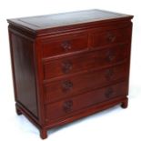 A Chinese hardwood chest with an arrangement of two short and three long drawers, 92cms wide.
