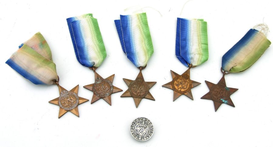 Five WWII Atlantic Star medals together with a For Loyal Service lapel badge