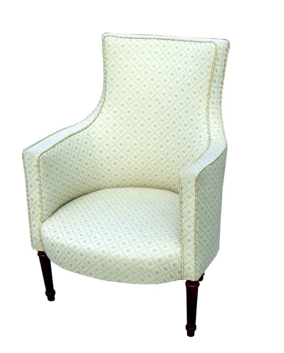 A French upholstered armchair on turned and reeded legs.