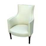 A French upholstered armchair on turned and reeded legs.