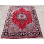 A Persian Meshed hand knotted wool carpet with central foliate design within foliate borders, on a