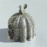 An Indian silver coloured metal trinket box of circular lobed form, with repousse decoration and