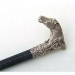 A Victorian woven leather riding whip with silver handle in the form of a horses head with saddle
